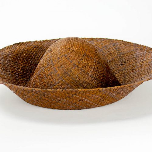 A chocolate brown flat weave raffia hatbody with finished edge