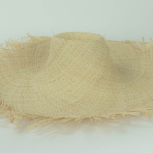 Natural, undyed flat weave raffia with raw edge and 5 inch brim. Remains soft and supple, will accept dye.