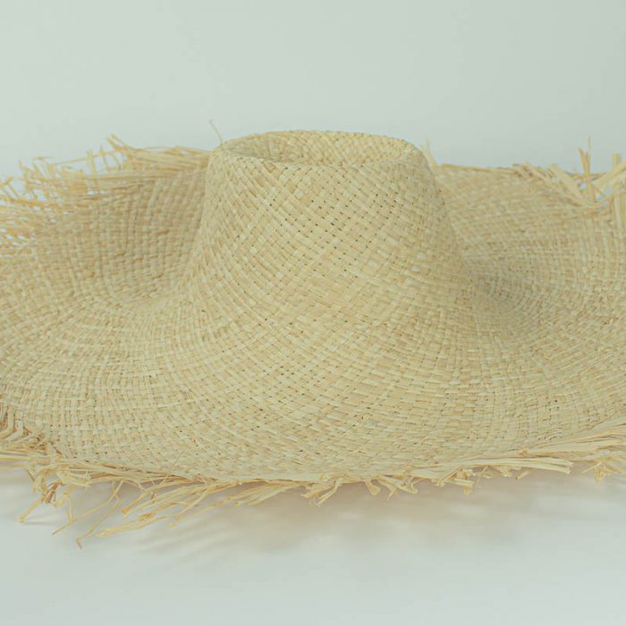 Natural, undyed flat weave raffia with raw edge and 5 inch brim. Remains soft and supple, will accept dye.