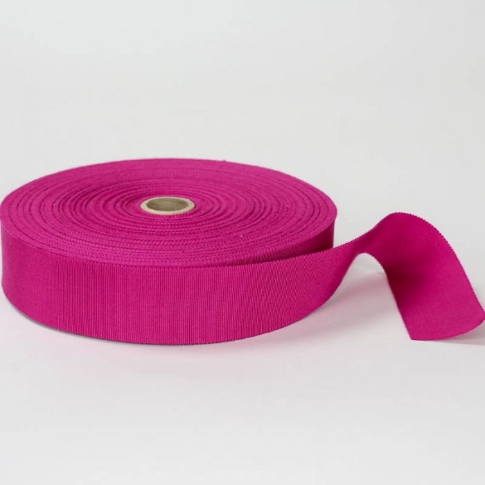 Magenta. Made in France. Blend of 44% rayon/ 56% cotton grosgrain belting with a saw-tooth edge.