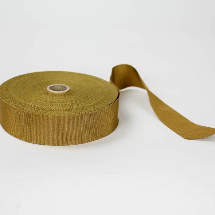 Golden Tan. Made in France. Blend of 44% rayon/ 56% cotton grosgrain belting with a saw-tooth edge.