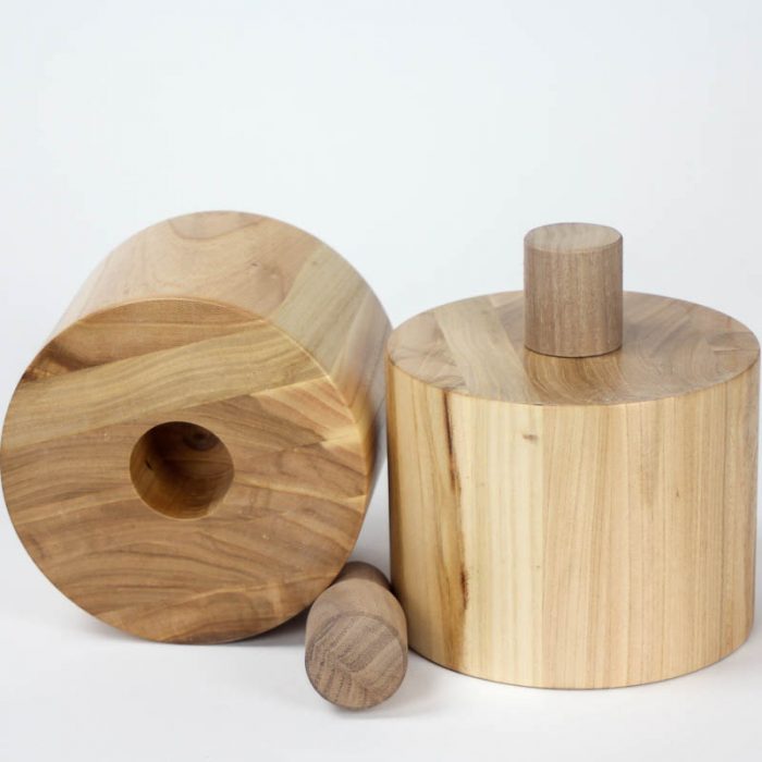 Block spinner with removable center peg. Both peg and spinner are two sided allowing it to be used with various blocks.