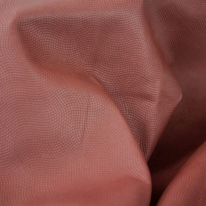Small raised pattern. Supple and soft leather, thickness of .65-.75mm, and blockable. Dyed all the way through.
