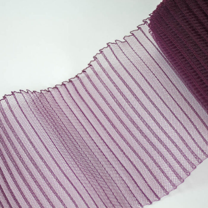 Plum polyester, very flexible, 1/4 inch pleats.