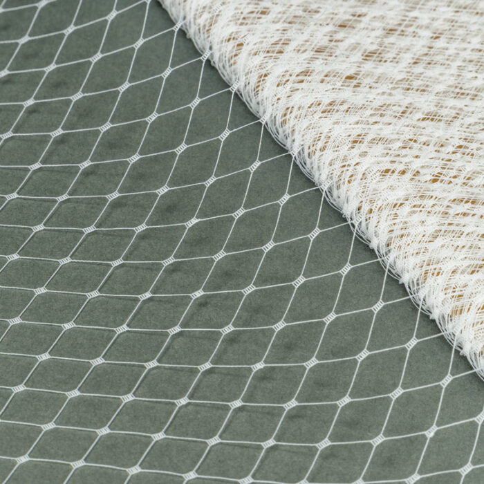 White Merry Widow pattern with 1/2 inch diamond opening, 12 inch width, 100% nylon. 